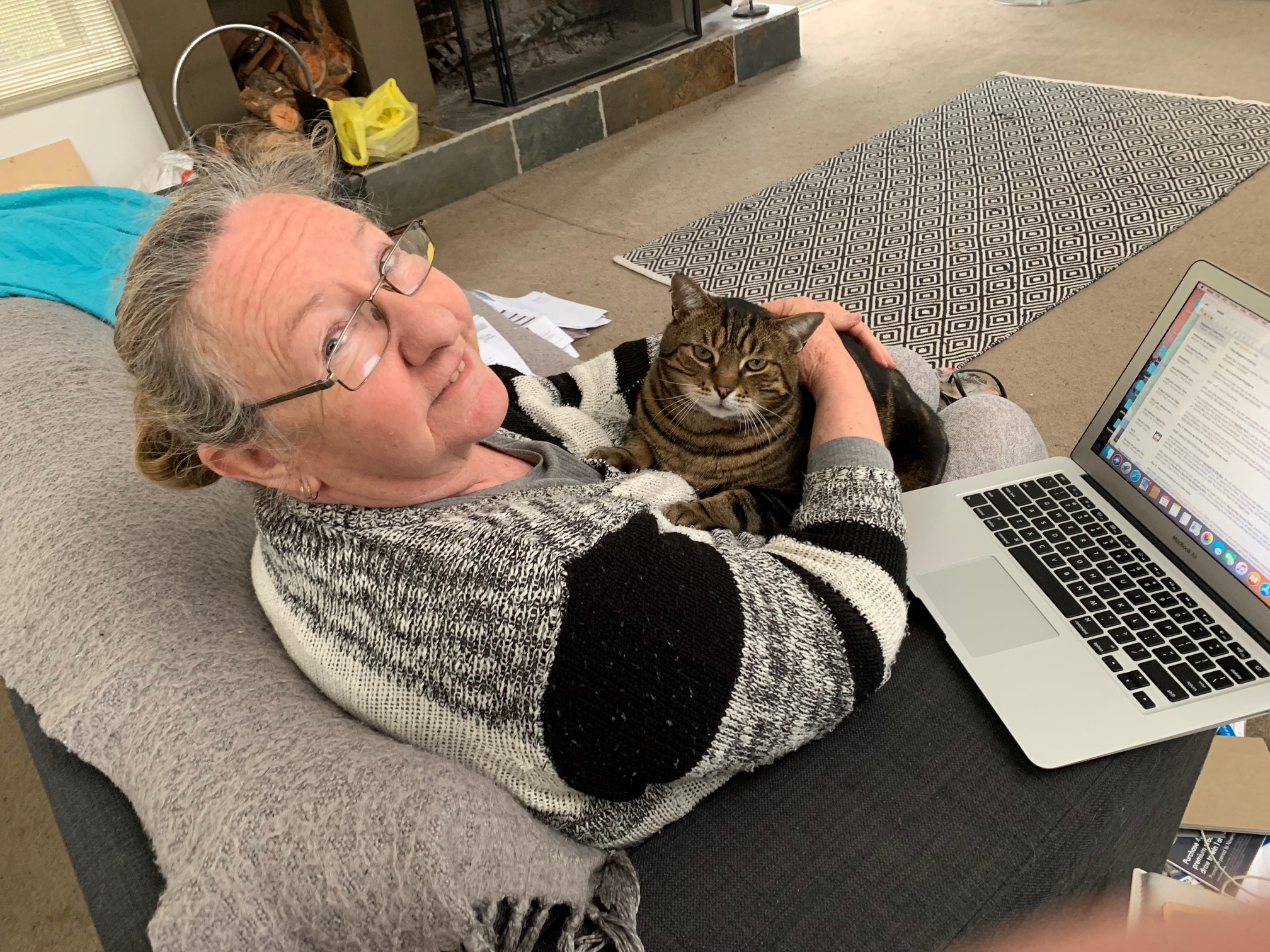 Sharyn with Joshy the cat and her laptop.